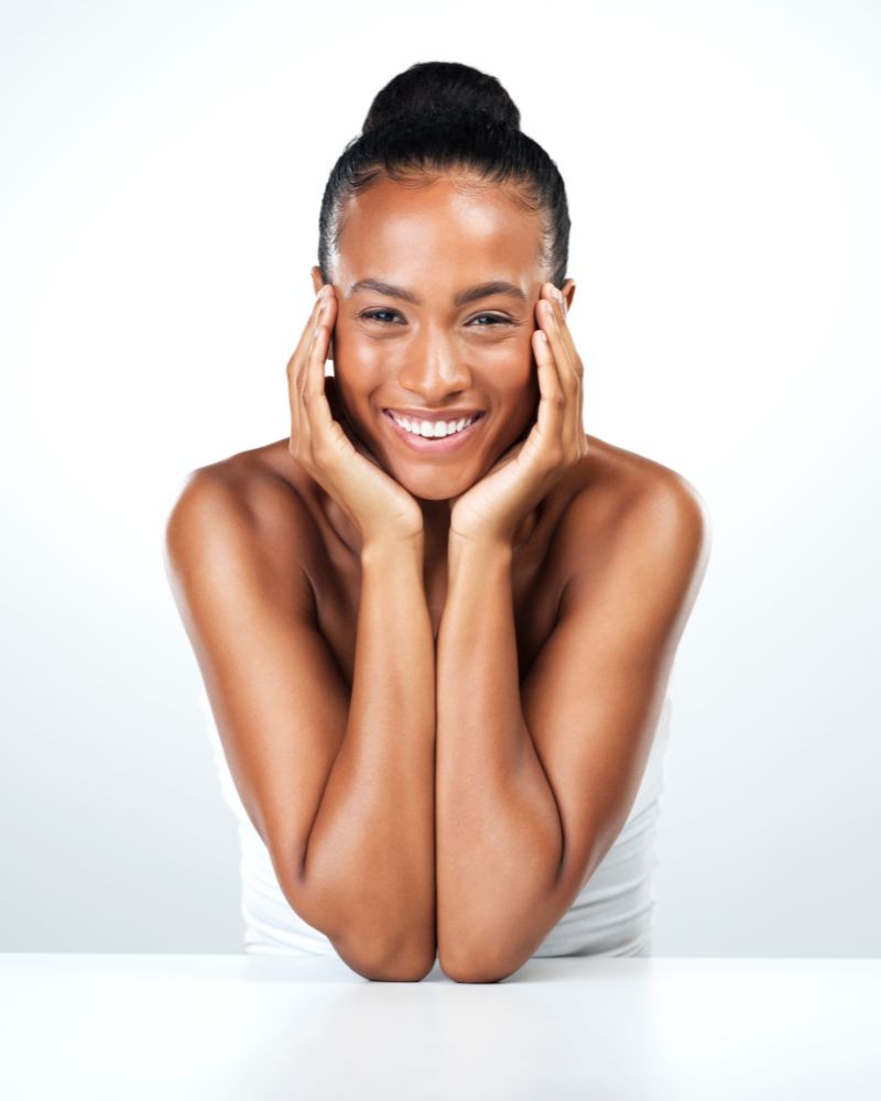 Woman smiling with hands on her face