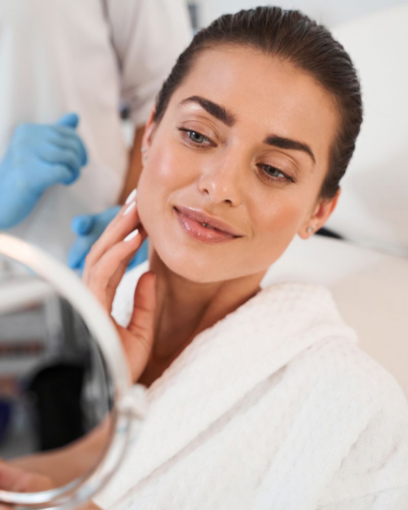 Women looking a face in mirror